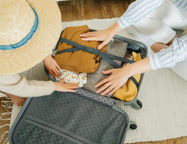 Two kids in sunglasses splash in a pool, smiling and having fun.