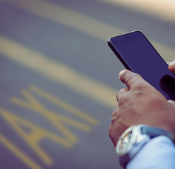  In a gym, a man is positioned next to a barbell