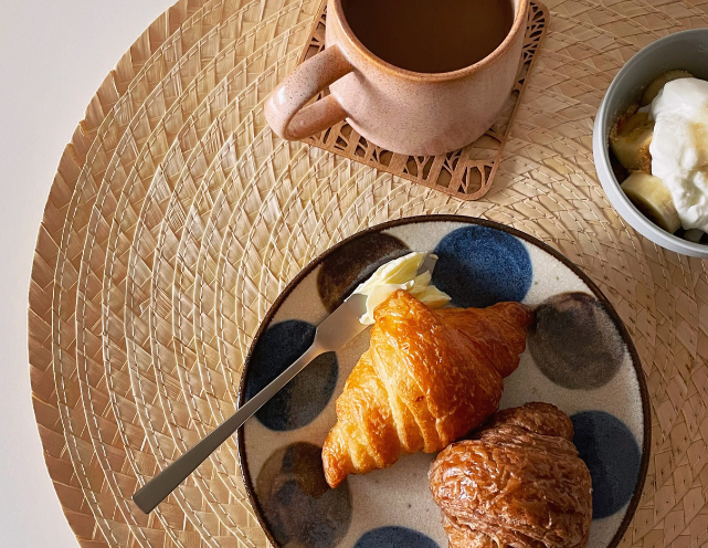  A table set with various plates of food and drinks, showcasing a colorful and inviting meal arrangement.