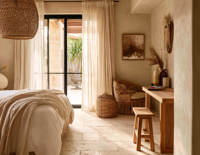 A person is opening the door to a hotel room.